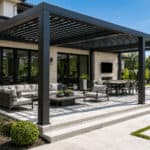 Modern backyard pergola with outdoor seating and dining area under a slatted roof.